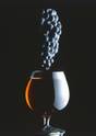 Grapes Over a Glass of Wine