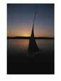 Sunset outlines the curve of a felucca sail on the Nile River