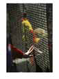 A hand reaches out to touch a name on the Vietnam Wall