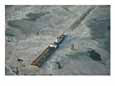 Tugboat pushing barge through winter ice on the Chesapeake Bay