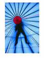 The figure of a person is silhouetted atop a hot-air balloon