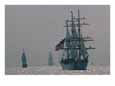 The United States Coast Guard Ship Eagle with several other sailing ships.