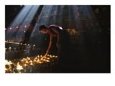 A Buddhist monk lights devotional lamps inside Jokhang Temple