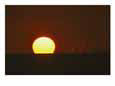 The glowing orb of the setting sun