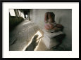 The Headless Statue of a Seated Buddha Sits in a Hallway in a Buddhist Temple
