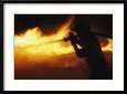 Fire-fighter battling a blaze at night
