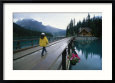 A Woman Crosses a Wooden Bridge to the Emerald Lake Lodge