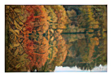 Fall foliage around Churchill Lake is reflected in the still water