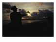 A Cowboy on His Horse Enjoys Sunrise on a Beach