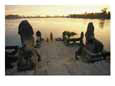 Two Buddhist Monks Sit at the Waters Edge at a Lake Temple in the Angkor Wat Complex