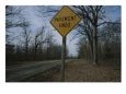 A Road Sign, Riddled with Buckshot