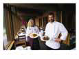 The Emerald Lake Lodge chef and a waitress display plates of food