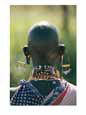 Portrait of an elaborately dressed African seen from behind