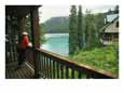A Woman Looks out on Emerald Lake from an Emerald Lake Lodge Balcony