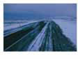 A road runs through a snowy landscape