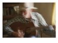 Panned View of a Cowboy Playing Country Tunes on a Guitar