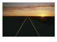 A view at sunrise of the Indian Pacific Railroad crossing the Nullarbor Plain