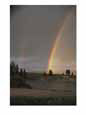 Two rainbows arcing over a body of water