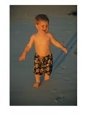 A toddler walks the beach on Bora Bora Island