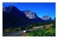 Car Driving on Road with Mountain Range Glacier National Park, Montana, USA