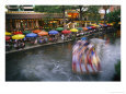 The Blur of a Passing Tourist Boat Along the Colorful Riverwalk