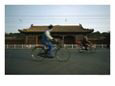 Man on a Bicycle Passes by the Back of the Forbidden City
