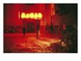 Motorcyclists outside a Karaoke Bar with a Neon Sign in Hunan