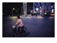 Woman Rides a Bike at Night under a Newly Built Elevated Roadway