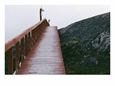 Red Wooden Walkway Leads over Granite Rocks