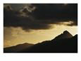 Peaks of a South Pacific Island at Sunset with Dark Clouds Overhead