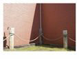Rope Fence Around Corner of Red Wooden Building