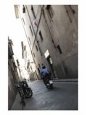 Apartment Buildings and Alley with Bike and Male Adult Riding Scooter