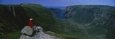 Person Sitting on Cliff, Ten Mile Pond, Gros Morne National Park, Newfoundland and Labrador, Canada