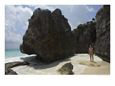 A Woman Stands on a Rock on the Beach in Tulum Scenic Beach & Ocean