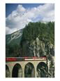 A Train Passes into a Tunnel in the Mountains of Switzerland