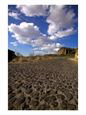 A Cobblestone Road Beneath a Cloudy Blue Sky Scenic Streets & Roadways