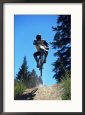 Cyclist on Dirt Path Leaping Through the Air
