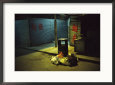 Pile of Garbage Next to a Trash Can on a Hong Kong Street at Night