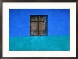 Closed Window Shutters Against a Blue Wall