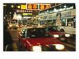 Kowloon Street Scene at Night with Neon Signs, Buses, and Taxis