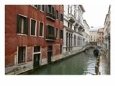 Stone Bridge Between Buildings over Venetian Canal