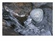 Rock with the Word Smile in Rushing Water