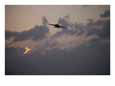 A Jet Comes in for a Landing on an Aircraft Carrier at Twilight