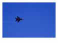 A Military Jet Speeds Through a Clear Blue Sky
