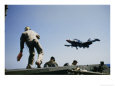 A Fighter Plane Lands Onboard an Aircraft Carrier