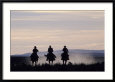 Three People Riding Horses