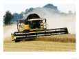Yellow New Holland Combine Harvester Harvesting Wheat Field, UK